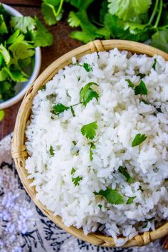 white rice in a bamboo bowl with cilantro and parsley on the side