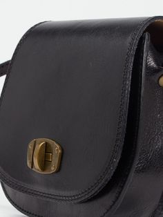 The black leather satchel, with a front turnlock is the perfect everyday bag.Crafted in carefully selected Italian leather, and perfectly sized to fit all your essentials, making it the perfect go-to day bag.Featuring a long comfortable thin strap with can be worn on the shoulder or across body. With a zipped interior pocket and a secure front lock in antique finish for keeping your essentials safe!100% Calf Leather Adjustable cross body buckle strapTwist lock and zip fasteningInner pocket19 cm Black Leather Satchel, Vegan Leather Bag, Day Bag, Saddle Bag, Everyday Bag, Antique Finish, Backpack Purse, Leather Satchel, Ballerinas