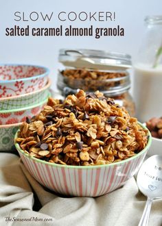 a bowl filled with granola sitting next to other bowls