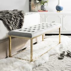 a living room with a white couch and ottoman