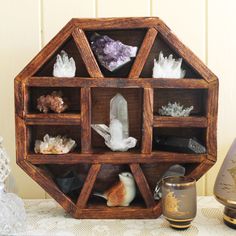 a wooden shelf filled with crystals and rocks