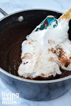 a pan filled with chocolate and marshmallows on top of a white counter