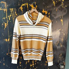 "The perfect vintage 70's striped off-white and beige knit turtleneck sweater. Off-white, with horizontal beige and black stripes.  Loose fit turtle neck. Soft 100% acrylic.  Made by Bobbie Brooks.  Best for a small/medium. Such a perfect piece! Measurements laying flat: fabric stretches Armpit to armpit: 19\" Length: 22\" Sleeve length: 23\"" Retro Cream Top For Fall, Vintage Turtleneck Tops For Fall, Beige Knitted Retro Sweater, Beige Long Sleeve Retro Sweater, Retro Long Sleeve Cream Sweater, 80s Turtleneck, 1970s Turtleneck, Bobbie Brooks, White And Beige