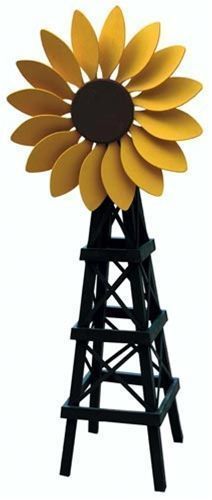 a large yellow sunflower sitting on top of a wooden tower in front of a white background