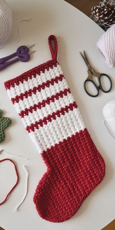 crocheted stocking, scissors and yarn on a table