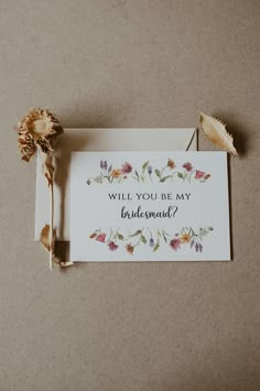 a card that says will you be my bridesmaid? with flowers on it