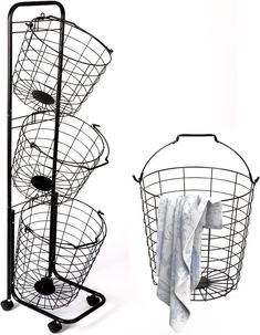 two metal baskets sitting next to each other on top of a white surface with towels in them