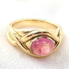 About This Piece: Metal: 18k yellow gold Measurements: Weight: 8.3 gramsWidth at Top: 10mm Size: 6 Stone: Pink Tourmaline - 6mm x 8mm Hallmarks: 750 (c) Tiffany & Co 2948aoxo Yellow Gold Tourmaline Ring, Yellow Gold Tourmaline Ring With Polished Finish, Yellow Gold Tourmaline Cabochon Ring, Pink Tourmaline, Tiffany & Co., Band Ring, Band Rings, Tourmaline, Gemstone Rings