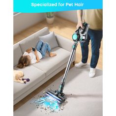 a person vacuuming the floor with a dog laying next to it on top of a couch