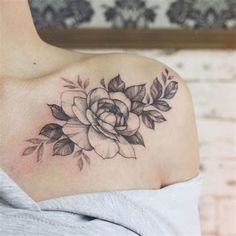 a woman with a rose tattoo on her shoulder