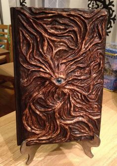 an intricately carved book on a wooden table