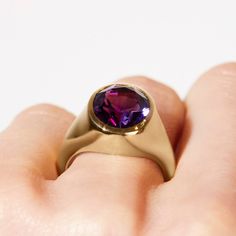 Take your style to a higher level with the magnificent Aphrodite statement ring featuring an oval amethyst made with Fairmined 18k yellow gold by Chroma. • Fairmined 14k yellow gold • 4.90ct Oval Amethyst • Band Width: 2mm - 6mm • In stock in size 6. This ring is able to be resized, please allow 4 weeks. Designed and crafted by us in NYC using recycled gold, conflict-free diamonds and responsibly sourced gemstones. The Fairmined program certifies gold created by small scale mining organizations, Timeless Oval Gold Amethyst Ring, Gold Amethyst Ring With Modern Style, Timeless Gold Oval Amethyst Ring, Timeless Yellow Gold Amethyst Ring With Oval Shape, Modern Yellow Gold Amethyst Ring, Elegant Amethyst Signet Ring For Anniversary, Modern Gold Amethyst Ring With Oval Shape, Timeless Oval Amethyst Ring For Gift, Timeless Oval Amethyst Ring As Gift