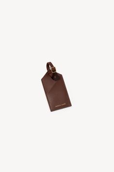 Luggage Tag - Janessa Leone Classic Leather Luggage Tag For Daily Use, Classic Leather Luggage Tag, Classic Brown Leather Luggage Tag, Brown Leather Luggage Tag With Leather Patch, Brown Leather Luggage Tag With Patch, Classic Brown Luggage Tag For Travel, Leather Brown Luggage Tag With Sleeve, Brown Leather Luggage Tag With Sleeve, Brown Leather Luggage Tag For Travel