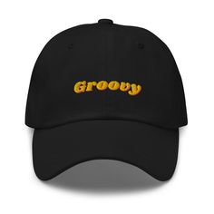 Step back in time with this retro 'Groovy' embroidered black cap, the perfect accessory for any vintage enthusiast. Crafted with high-quality materials, this classic dad hat combines modern comfort with a nostalgic flair. The vibrant yellow and orange 'Groovy' text stands out beautifully against the sleek black fabric, making it a stylish addition to any casual outfit. Features: - High-quality embroidery - Adjustable strap for a perfect fit - Comfortable and durable fabric - Ideal for casual wea Groovy Text, Vintage Style 70s, Hat For Men, Vintage Mode, Hat For Man, Black Cap, Mode Vintage, Dad Hat, Vintage Stil