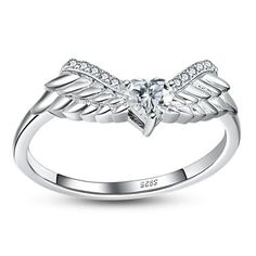 The Classy Angel Wings Anniversary Band Ring Enhancer from the Ginger Lyne Collection is a beautifully crafted piece that adds a touch of celestial grace to any jewelry ensemble. This enhancer features a solitaire heart-cut clear cubic zirconia, 4mm in size, and set in a secure three-prong setting. The AAAA quality stone is flanked by delicately designed angel wings, with the entire wing-to-wing span measuring 18mm, creating a breathtaking silhouette on the finger. Crafted with high-quality .925 Angel Wing Ring, Ring Enhancer, Mom Ring, Ring Ideas, Anniversary Bands, Anniversary Ring, Statement Ring, Anniversary Rings, Angel Wings