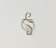 "This listing is for one (1) unique and eye-catching statement ring. The Silver Coiled Midi Ring can be ordered in any normal ring size or midi ring size. Your choice of Silver Plate or Sterling Silver wire is hand shaped in a \"S\" formation, and looks great alone and paired with other rings or alone. Due to the open shape, the ring is slightly adjustable, and great to give as a gift! Specify ring sizes during checkout: An unspecified order will revive a most midi ring size 3/4 Nickel free." Modern Twist Adjustable Midi Rings As Gift, Adjustable Midi Rings With A Modern Twist For Gifts, Modern Twist Wire Wrapped Rings For Gifts, Modern Twist Wire Wrapped Rings As Gift, Wire Wrapped Rings As A Modern Gift, Silver Spiral Midi Rings As Gift, Modern Twist Metal Rings As Gift, Handmade Adjustable Swirl Ring, Handmade Spiral Minimalist Rings