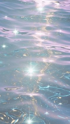 the sun shines brightly in the water as it reflects on the surface with blue and purple hues