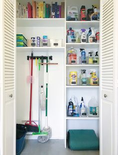 a white closet filled with lots of cleaning supplies