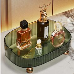 a glass table topped with bottles and perfumes