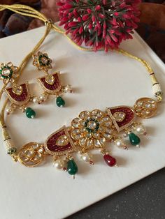 One of our favorite picks for the wedding season ♥️ The gorgeous choker is beautifully handcrafted by our skilled Indian craftsmen in Kundan stones, multi coloured beads, mini pearls, and gold plated. The beautiful Kundan earrings add to the traditional ethnicity of the piece. Material: Brass with gold plating Dimensions Weight of choker is 39 g. Choker comes with adjustable Dori. Weight of earrings is 18 g per pair. Length of earrings: 6.55 cms, push back closure. Width of earrings: 2.5 cms. Multicolor Gold-plated Kundan Necklace Gift, Multicolor Gold Plated Kundan Necklace Gift, Gold Plated Choker For Festivals And Gifts, Gold Plated Choker For Festivals As A Gift, Celebration Multicolor Gold Plated Bridal Necklace, Elegant Multicolor Festive Choker, Kundan Jeweled Choker As Gift, Jeweled Kundan Choker As Gift, Kundan Jeweled Choker For Gift