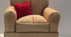 a chair with a red pillow sitting on top of it