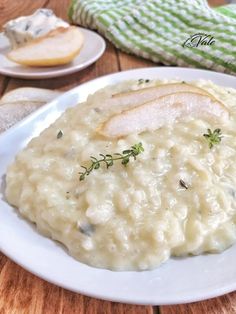 a white plate topped with mashed potatoes covered in gravy