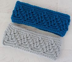 two crocheted headbands sitting next to each other