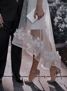 a bride and groom standing next to each other