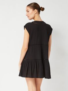 Our Gari dress has a breezy, tiered silhouette perfect for slipping on and off over your swimsuit when on vacation. It's cut from airy cotton-crepe with a naturally crinkled texture, and has slim tassel neck ties that can be worn tied or open. Wear yours on or off the beach with sandals and a woven tote. DETAILS Color: Black Fabric: 100% Cotton Crinkle Crepe Unlined Slips on Split neckline with cotton tassel ties Cap sleeve Cotton lace trim detail at placket and skirt seams Style #2411CCG6013BK Cotton Tiered Dress With Ruffle Hem For Beach, Beach Tiered Cotton Dress With Ruffle Hem, Flowing Cotton Tiered Dress For Beach, Flowy Cotton Tiered Beach Dress, Flowy Cotton Tiered Dress For The Beach, Black Tiered Dress For Summer Vacation, Cotton Tiered Dress For Beach, Black Tiered Beach Dress For Summer, Black Tiered Dress For Beach In Summer