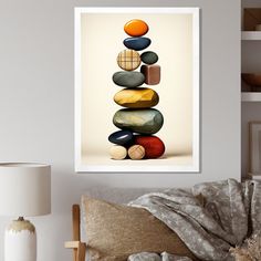 a stack of rocks sitting on top of a bed next to a lamp