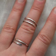 This adjustable hammered sterling silver ring is designed for both men and women who enjoy wearing minimalist style jewelry. This ring is super lightweight and comfortable, making it the perfect everyday wear with any outfit. Stack it or mix and match with other metals. Puffy fingers are no match for this ring! Completely handcrafted by me (Kahlia) in Washington State out of my school bus work studio. Handmade with raw 925 sterling silver wire, this ring is hammered to perfection and polished to Everyday Adjustable Hammered Stackable Rings, Minimalist Hammered Sterling Silver Midi Rings, Everyday Minimalist Hammered Midi Rings, Adjustable Dainty Hammered Midi Rings, Minimalist Adjustable Hammered Midi Rings, Everyday Hammered Open Ring, Minimalist Hammered Ring With Open Band, Minimalist Hammered Toe Ring, Minimalist Hammered Open Band Ring