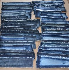 many pieces of blue jean fabric are laid out on the floor and ready to be sewn