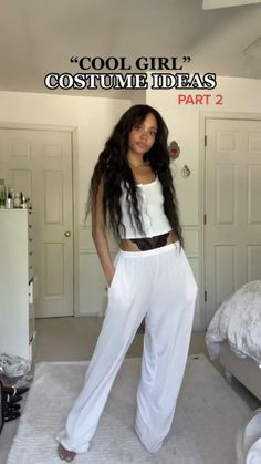 a woman standing in a bedroom next to a bed