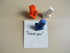 a piece of paper that says thank you next to two legos on top of it