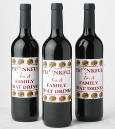 three bottles of wine with the label for a family that drinks on them, sitting next to each other