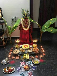 a person sitting in front of a table with food and candles on top of it