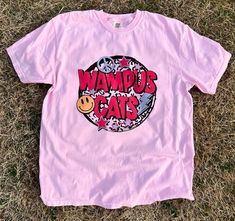 Get this popular new Wampus Cat colorful throwback shirt and show off your school spirit in style!  Each shirt is printed in-house by me using high-quality materials on a Comfort Colors shirt, known for its exceptional comfort, style, and durability. Available in unisex sizes S to 3X, and youth sizes, we've got you covered regardless of your preferred fit. The Wampus Cat paint splatter shirt features a classic crew neck and short sleeves, making it suitable for year-round wear. The flattering si College Shirt With Graphic Print In Pink, College Graphic Print Pink Shirt, Pink Graphic Print Shirt For College, School Spirit Graphic Print Shirt For Streetwear, Pink Tops For Streetwear With School Spirit, Pink Tops For School Spirit Streetwear, Wampus Cat, Paint Splatter Shirt, Mascot Shirt