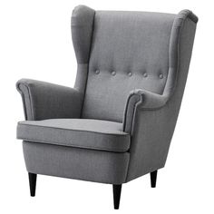 a gray chair with buttons on the back and arms, sitting in front of a white background