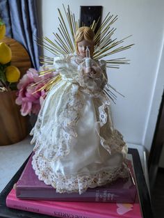 a doll sitting on top of two books