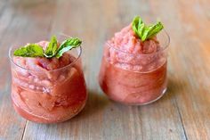 two glasses filled with ice cream on top of a wooden table