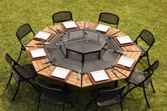 an overhead view of a table with chairs and plates on it in the middle of grass