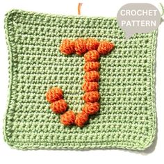 a crochet pattern with the letter j on it and an orange yarn ball