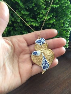 This is a Dainty Necklace with heart filigree. This piece is an authentic replica of the much appreciated Portuguese filigree. Made of very good quality metal, nickel free; with a gold or silver finish. PRODUCT VIDEO & # 8658; https://bit.ly/2CrMS3t On this metal base it has a small and elegant replica of Portuguese tile, in white and blue.  The size of the heart is about 5.5 / 6 cm.  The chain is fine, with a gold or silver finish; of approximately 30/35 cm. The original and highly valued Portuguese filigree are made of very fine gold. We at Luso Tailes Jewelry, offer beautiful REPLICAS, of excellent quality, but (they are not real gold). They also have a detail of Portuguese tiles. All this makes each necklace a unique piece. THE CARE OF HAVING: 1) Care must be taken not to expose perfum Traditional Heart-shaped Jewelry For Festive Occasions, Traditional Heart Shaped Jewelry Gift, Traditional Heart-shaped Jewelry Gift, Filigree Heart Pendant Jewelry For Gifts, Heart Pendant Filigree Jewelry Gift, Ornate Heart-shaped Jewelry With Intricate Design, Ornate Gold Heart Pendant Necklace, Elegant Etched Heart Pendant Jewelry, Elegant Etched Necklace As A Gift