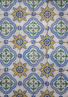 an artistic tile design in blue, yellow and green