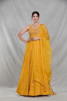 Mango yellow sleeveless full length gown with Mughal bloom embroidery using thread, sequin, beads and cutdana highlights. Paired with a ditsy sequin floret work dupatta. - Aza Fashions Sleeveless Wedding Dress For Eid, Traditional Yellow Maxi Dress For Wedding, Yellow Floor-length Anarkali Set With Chikankari Embroidery, Designer Yellow Georgette Gown, Yellow Anarkali Set With Chikankari Embroidery, Floor-length, Sleeveless Georgette Dress For Eid, Yellow Floor-length Dress For Eid, Floor-length Yellow Dresses For Eid, Yellow Floor-length Dresses For Eid