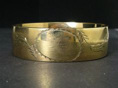 Cute victorian era bangle with engraved designs around the blank face. 19mm tall face. In great overall condition with no dents and very little wear. tested GF. Fits an approximate 7" wrist. Hinge and clasp works well. Antique Engraved Cuff Bracelet For Formal Occasions, Victorian Etched Cuff Bracelet For Formal Occasions, Victorian Engraved Cuff Bracelet For Ceremonial Occasion, Antique Engraved Yellow Gold Cuff Bracelet, Victorian Round Cuff Bracelet For Formal Wear, Vintage Yellow Gold Cuff Bracelet For Ceremonial Occasions, Vintage Yellow Gold Engraved Cuff Bracelet, Antique Cuff Bracelet For Formal Occasions, Vintage Engraved Yellow Gold Cuff Bracelet