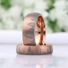 two wedding bands with trees on them