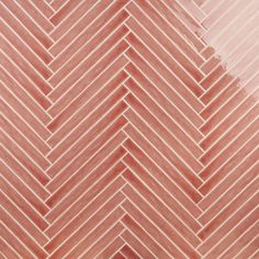 a close up view of an orange and pink herringbone pattern tile wallpaper background