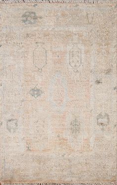 an antique rug with faded edges and fringes on the bottom, in neutral tones