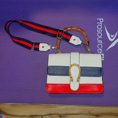 White Handbag With Navy & Red Stripes On Front, Faux Bamboo Style Handle, Navy & Red Strap Attached As Well.... Strap Can Be Taken Off And Adjusted To Be A Little Longer, One Little Mark On Back Of Bag That I Pointed At But It's Barely Noticeable, Inside In Great Condition As Well, Only Used Once So Almost Like New, No Name Brand, 9 Inches Across, 6 Inches Top To Bottom, A Little Over 1 Inch Wide But That's With Nothing Inside, It Has 2 Sections And 2 Pockets Inside, Any Questions Ask Trendy Red Bag With Branded Hardware, Trendy Red Bags With Branded Hardware, Trendy Red Shoulder Bag With Branded Hardware, Trendy Red Shoulder Bag With Strap, Red Rectangular Bag With Strap, Rectangular Red Bag With Strap, Red Rectangular Shoulder Bag With Strap, Red Crossbody Bag With Strap, Chic Multicolor Shoulder Bag With Branded Hardware